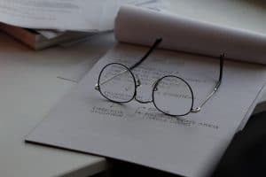Eye Glasses sitting on a stack of papers